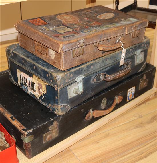 Three leather suitcases, two with liner labels